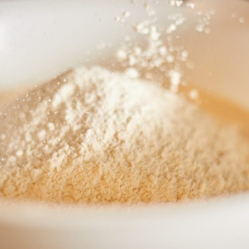 white flour splashing out of bowl